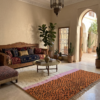 Handwoven Azilal rug with ivory top and orange abstract pattern in Moroccan interior