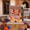 Handwoven Boujaad rug with colorful zigzag tribal pattern in Moroccan interior
